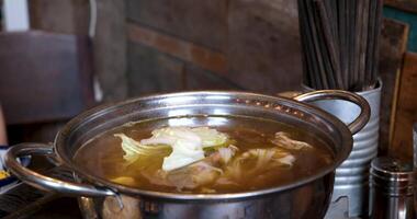 Add white cabbage to soup Vietnam Pho soup prepared in a restaurant yourself on the table video