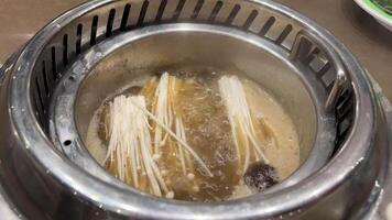 preparing a mushroom dish enoki mushrooms are boiled in a pan Enoki mushrooms Also known as winter mushrooms. These long, thin, tender mushrooms grow in clusters all year round. video