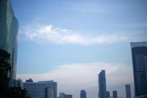 orange blue skyscape background with cloud and city town building in evening of the day sunset twilight dusk time photo