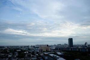 reflection light sun ray from beside white clouds in cloudy daytime with dusk sunrise sunset twilight time sky with city high view photo