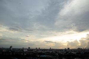 reflection light sun ray from beside white clouds in cloudy daytime with dusk sunrise sunset twilight time sky with city high view photo