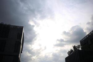 reflection light sun ray from beside white clouds in cloudy daytime with dusk sunrise sunset twilight time sky with city high view photo