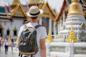 Back view of a traveler man with backpack at Thailand pagoda photo