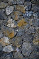 Granite stones of different shapes and colors. Wall cladding. Background selective focus with copy space. 2 photo