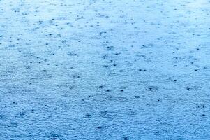 Defocus blurred transparent blue colored clear calm water surface texture with splashes and bubbles.2 photo