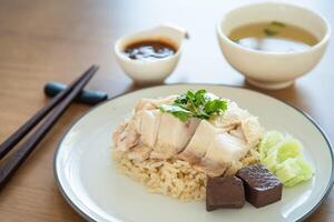 Closed up chicken rice with salted soya beans sauce and soup as traditional Singapore street food photo