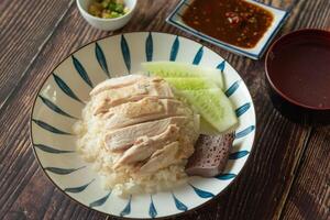 Top view chicken rice with salted soya beans sauce and soup as traditional Singapore street food photo