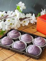 Homemade Chinese pastry cake, stuffed bean and taro in packaging in cafe photo