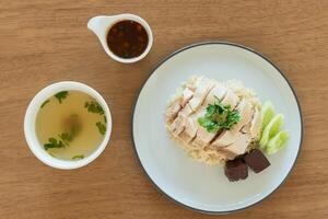 Top view chicken rice with salted soya beans sauce and soup as traditional Singapore street food photo