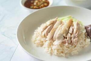 Hainanese Chicken rice with salted soya beans sauce and soup photo