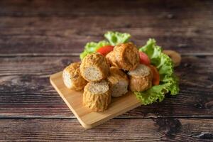 Closed up deep fried chicken roll as Chinese-Thai fusion style serve with sweet sauce photo