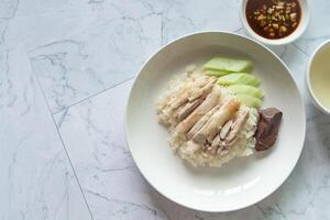 Top view Hainanese Chicken rice with salted soya beans sauce and soup photo