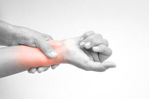 Woman with pain in wrist on white background with clipping path. Healthcare and office syndrome concept. photo