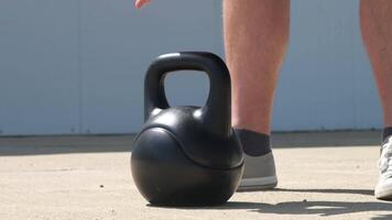 sports and leisure. strong Caucasian man working out using kettlebell in the park video
