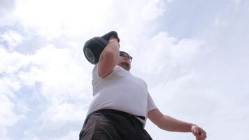 sports and leisure. strong Caucasian man working out using kettlebell in the park video