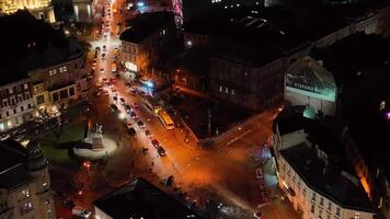 The night ancient city in lights. Top view of traffic on the roads of the sleeping area. Lighting in high-rise buildings. Aerial view video
