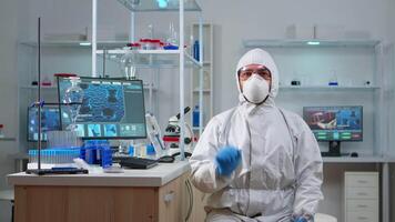 Lab technician in ppe suit working with virtual reality in chemical laboratory. Team of biologists examining vaccine evolution with high tech and technology researching treatment against covid19 virus video