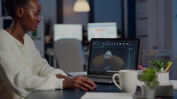 Excited black woman industry architect working on modern cad program overtime sitting in start-up office. Industrial engineer studying prototype idea on pc showing cad software on device display video