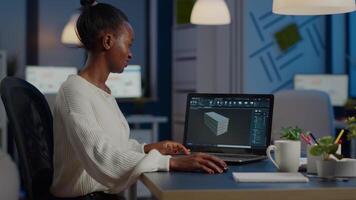 Enthusiastic african engineer analysing cad software to design a 3D concept of container working overtime in start-up company for prototype. Overworked woman studying in office using technology video