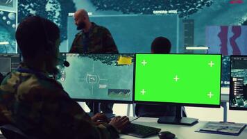 Control room operator tracking all ships anchoring along the coast line, uses isolated chromakey display in command post. Military personnel helps with real time information, reconnaissance. Camera B. video