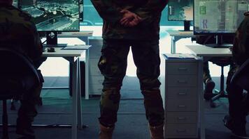 Colonel overseeing special operation to gather intelligence in control center with CCTV surveillance information on a big screen. Specialist targeting enemy military power base. Camera A. video