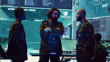 Army superior officers creating an attack plan using a hologram to gather real time information, working together to ensure national safety in a command center. Military operations. Camera A. video