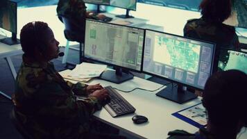 Woman army officer operates on gps surveillance footage to gather crucial information about enemy plans. Operator examines a satellite world map to provide support to field troops. Camera B. video