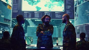 Army superior officers creating an attack plan using a hologram to gather real time information, working together to ensure national safety in a command center. Military operations. Camera B. video