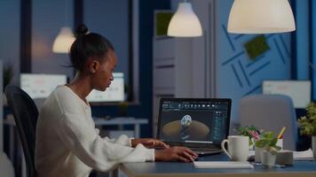 African woman engineer working in modern cad program with gear sitting at desk in start-up business office. Industrial employee studying prototype idea on laptop showing cad software on device display video