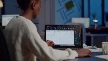 African engineer constructor designer architect analysing new bluilding plan in CAD program working in business office. Industrial woman employee studying prototype idea showing cad software on device display video