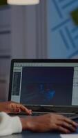 African gamer creator testing game over level interface, developing new design in midnight from business office using laptop. Player testing online games with technology network wireless. video