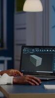 Enthusiastic african engineer analysing cad software to design a 3D concept of container working overtime in start-up company for prototype. Overworked woman studying in office using technology video