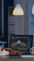 African woman engineer working in modern cad program with gear sitting at desk in start-up business office. Industrial employee studying prototype idea on laptop showing cad software on device display video