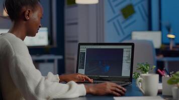 African gamer creator testing game over level interface, developing new design in midnight from business office using laptop. Player testing online games with technology network wireless. video