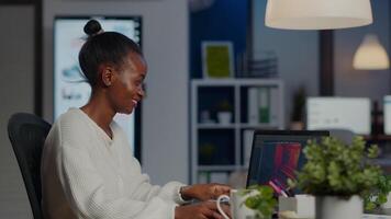 Black freelancer game developer typing on keyboard developing new level of videogame. African pro player testing game over level interface in midnight from business office using laptop. video