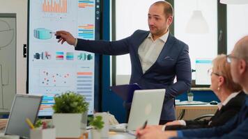 Executive manager presenting sales reports, financial evolution of start up company during conference meeting. Multiracial group of people working in boardroom discussing, briefing, planning project. video