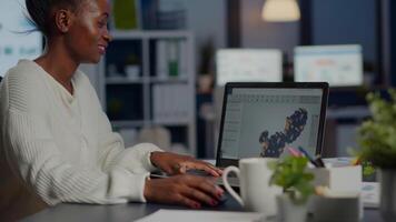 svart kvinna arkitekt arbetssätt i modern cad program över tid Sammanträde på skrivbord i börja företag kontor. industriell anställd studerar prototyp aning på bärbar dator som visar cad programvara på enhet visa video