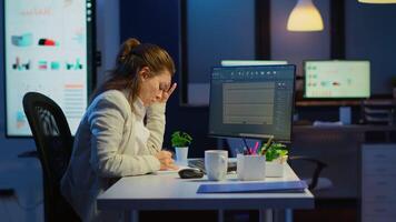 Tired engineer analysing cad software to design a 3D concept of container working overtime in start-up company for prototype. Overworked woman studying in office new modern model using technology video
