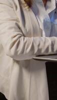 Vertical . Freelancer woman holding laptop, writting and looking at camera smiling standing in start-up company late at night. Focused employee using technology network wireless doing overtime for job reading. video