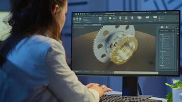 Woman architect working in modern cad program overtime sitting at desk in start-up business office. Industrial employee studying prototype idea on computer showing cad software on device display video
