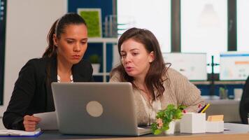 Manager office and creative director working in modern office using laptop sitting at desk developing startup idea. Diverse team of business people analyzing company financial reports from computer video