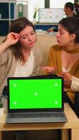 International business team talking to african woman discussing company plan with mockup laptop in front of camera. Leader explainig project strategy using green screen pc with chroma key display. video