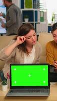 Diverse businesswomen analysing annual financial reports sitting on couch in back of laptop with green screen monitor. Leader explainig project strategy using greenscreen pc with chroma key display. video