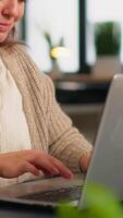 Close up of authentic happy professional employee sending mails sitting at desk in front of lapotop smiling, working financial startup company. Diverse team analyzes statistics data in modern office video