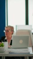Portrait of successful young entrepreneur standing looking at camera crossing arms and smiling. Manager working in professional start up financial business, modern company workplace ready for meeting video