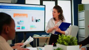 Business partners planning strategy at meeting conference, working with digital interactive whiteboard, discussing project statistics, sharing ideas. Corporate staff talking new business application video