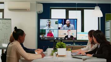 Team working by group call share ideas brainstorming negotiating use conference, pc screen view multi ethnic young people. Diverse people talking at virtual meeting, online discussion. video