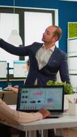 Business partner presenting company strategy to diverse team brainstorming in new startup office, analysing financial graphs from display, Multiethnical businesspeople working in professional start up video