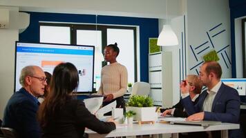 African project manager holding financial meeting showing statistical graphs and charts on interactive whiteboard touchscreen device. Executive director working in broadroom of creative agency. video
