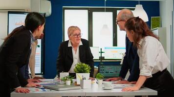 Group of diverse enthusiastic business people, marketing professionals, discussing project ideas during conference meeting, brainstorming startup company strategy sitting at office desk in broadroom video